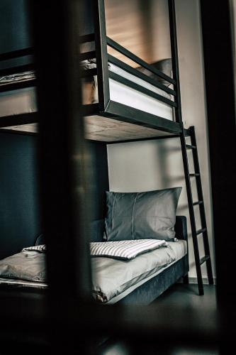 a room with two bunk beds and a ladder at Boutique Apartments OLD SCHOOL in Söll