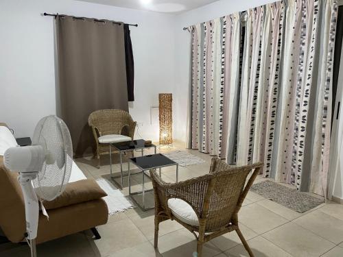 a living room with a couch and chairs at Tranquil Country Condo in Larnaca