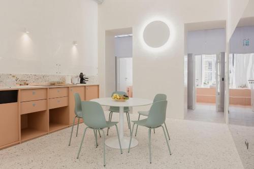 a kitchen with a table and chairs in a room at Flow Spaces in Budapest