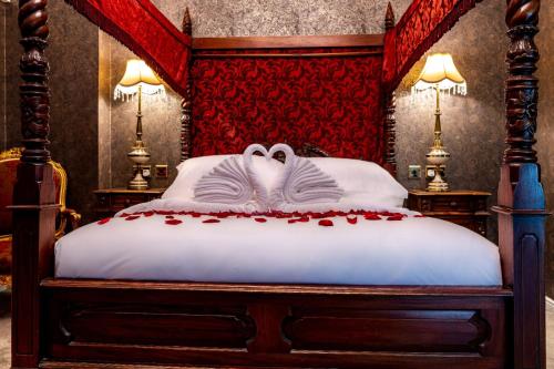 a bedroom with a bed with roses on it at Melville Castle Hotel in Edinburgh