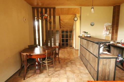 a kitchen and dining room with a wooden table and chairs at Arte in Kazbegi in Stepantsminda