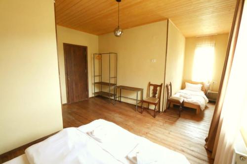 a bedroom with a mirror and a bed and a table at Arte in Kazbegi in Stepantsminda