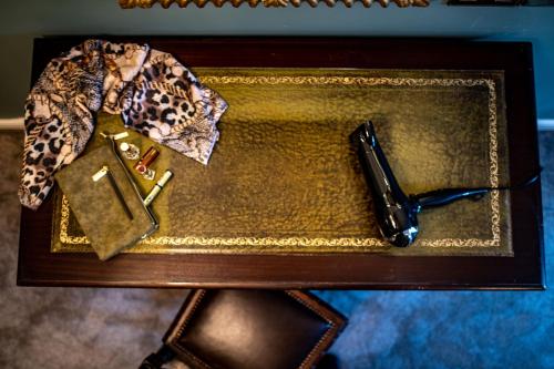 a table with a pen and a wallet on it at Melville Castle Hotel in Edinburgh