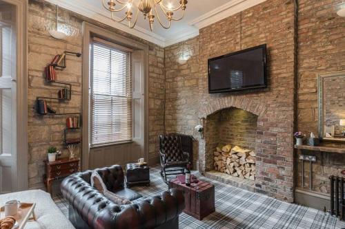 a living room with a couch and a fireplace at The Oldgate in Morpeth