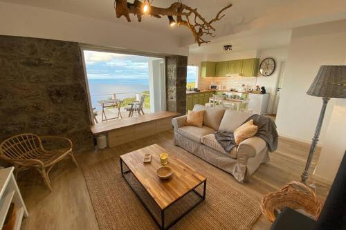 a living room with a couch and a table at Craftsman's House in Nordeste