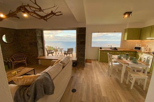 a living room and kitchen with a couch and a table at Craftsman's House in Nordeste