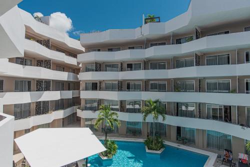 an image of an apartment building with a swimming pool at The Gallery Condos Playa de Carmen in Playa del Carmen