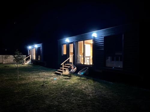 a small house at night with lights on it at Pixel - Tiny Campus in Tîrgu Secuiesc