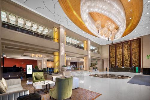 a lobby of a hotel with a large chandelier at Holiday Inn Foshan Nanhai Central by IHG in Foshan