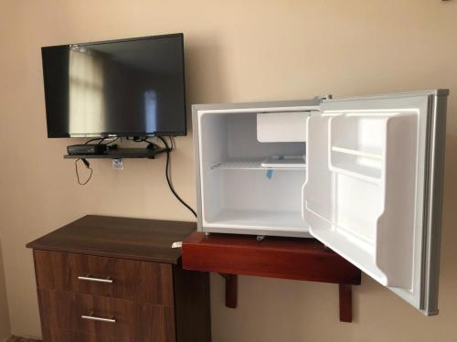 un frigorifero aperto con una TV sopra di Hostal Malania a Manta