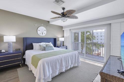 a bedroom with a bed and a clock on the wall at Olde Marco Inn #302 in Marco Island