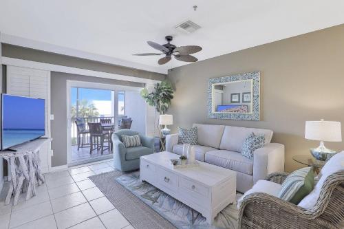a living room with a couch and a tv at Olde Marco Inn #302 in Marco Island