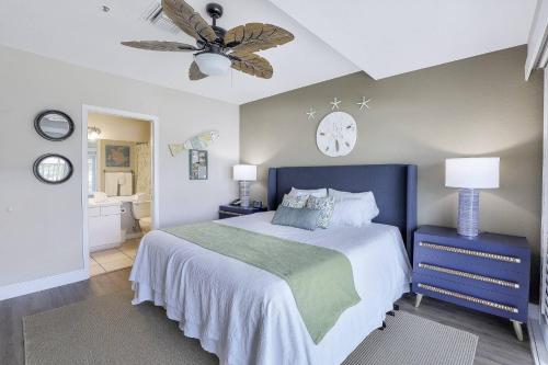 a bedroom with a bed and a clock on the wall at Olde Marco Inn #302 in Marco Island
