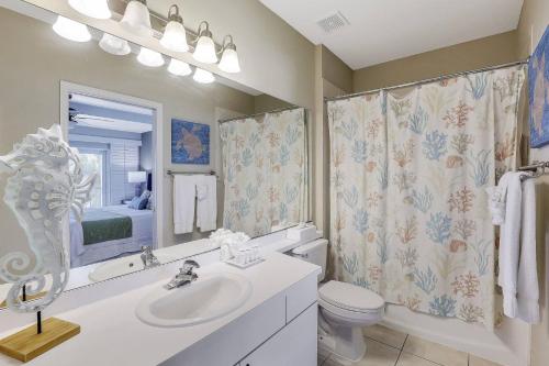 a bathroom with a sink and a toilet and a mirror at Olde Marco Inn #302 in Marco Island