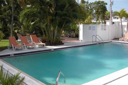 a large swimming pool with chairs and a pool at Olde Marco Inn #302 in Marco Island