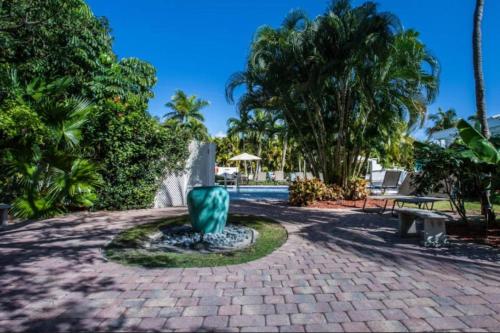 a fountain in a park with a bench and trees at Olde Marco Inn #302 in Marco Island