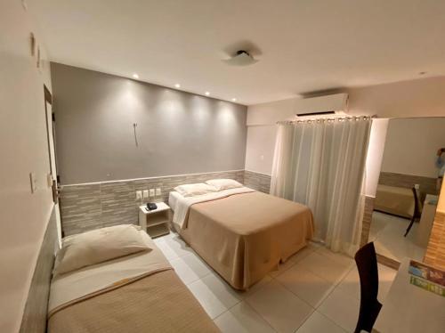 Ένα ή περισσότερα κρεβάτια σε δωμάτιο στο Hotel Costa do Atlântico