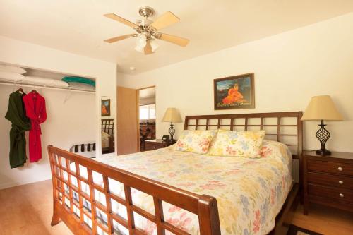 sypialnia z łóżkiem i wentylatorem sufitowym w obiekcie 5th Street Ohana w mieście Volcano