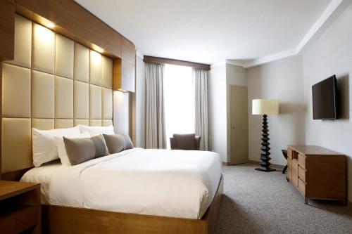 a hotel room with a large bed and a window at Grey Eagle Resort in Calgary