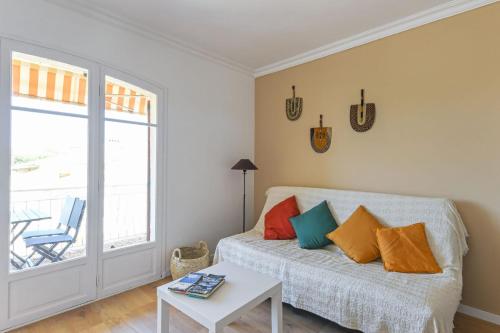 a room with a bed and a table and a window at Beautiful flat at 10 min walk from the beach in Saint-Cyr-sur-Mer - Welkeys in Saint-Cyr-sur-Mer