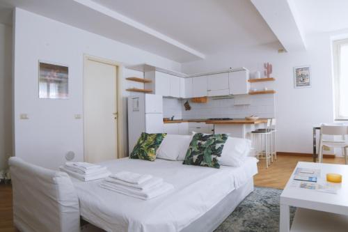 a white living room with a white couch at Parma Central Apartments in Parma