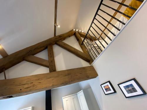 a staircase in a room with wooden beams at Apartment @ Booth Hall in Hereford