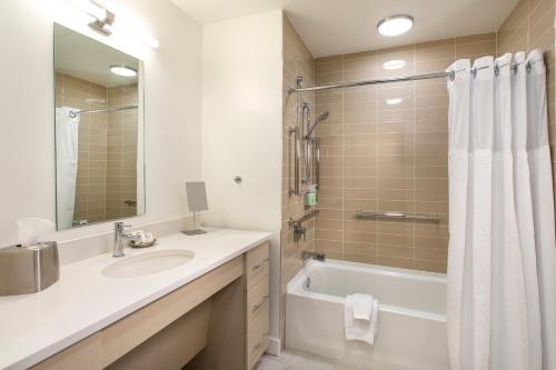 a bathroom with a sink and a tub and a shower at One Lakeside in Coeur d'Alene