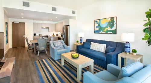 a living room with blue couches and a dining room at One Lakeside in Coeur d'Alene