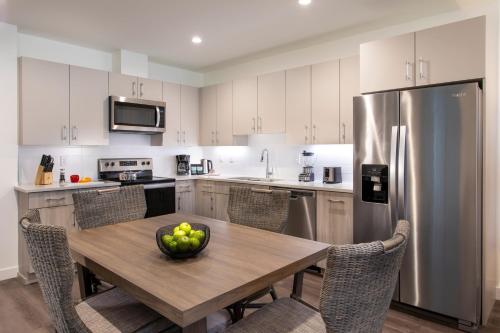 a kitchen with a wooden table with a bowl of fruit on it at One Lakeside in Coeur d'Alene