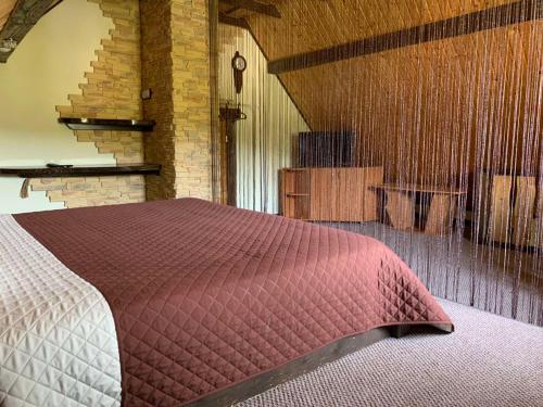 a bedroom with a red bed in a room at Зоряні Карпати in Slavske