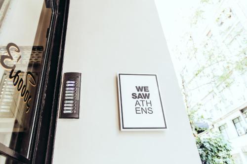 a sign on the door of a building that says we saw artemis at we saw athens in Athens