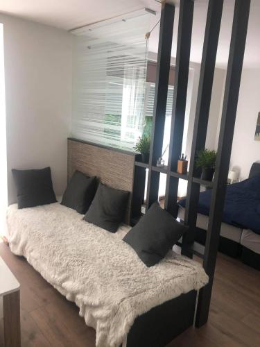 a bedroom with a large bed with black posts at Apartment in the center of the old city, Budžak 14 in Sarajevo