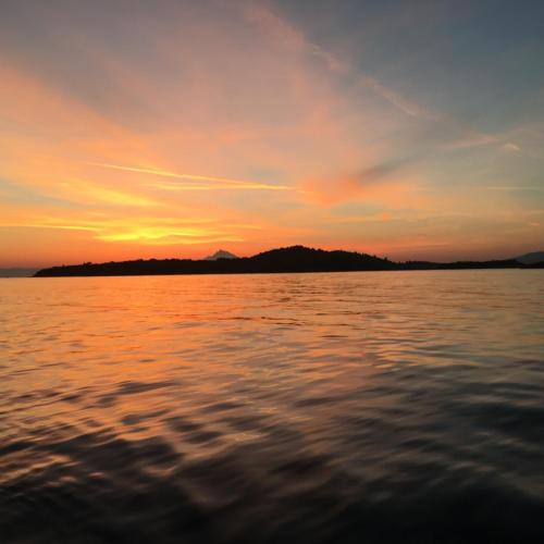 a sunset over a body of water at Elesta in Vourvourou
