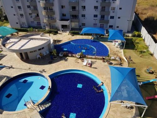 an overhead view of two swimming pools with blue tiles at Lagoa Quente Flat Service in Caldas Novas