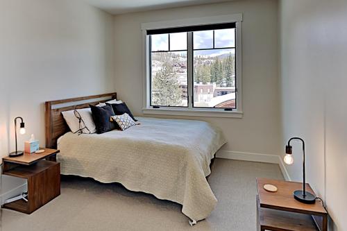 a bedroom with a large bed and a window at New Luxury Loft #307 With Huge Hot Tub & Great Views - 500 Dollars Of FREE Activities & Equipment Rentals Daily in Winter Park