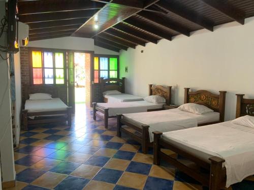 Postel nebo postele na pokoji v ubytování Hotel Campestre Los Chiguiros