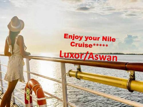 a woman standing on a boat looking at the water at Luxor Luxury Nile Cruises - From Luxor 04 & 07 Nights Each Saturday - From Aswan 03 & 07 Nights Each Wednesday in Luxor