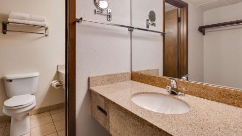 a bathroom with a sink and a toilet at Best Western Angus Inn in Great Bend