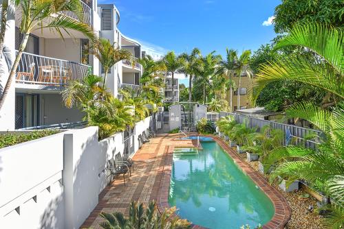 a swimming pool on the side of a building at Portobello Resort Apartments in Gold Coast