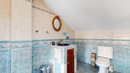 a bathroom with a sink and a toilet at Majestic Villa by the Beach Heated Private Pool & Jacuzzi in Benalmádena