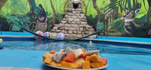 a plate of food on a table in a pool at Zayali Bacalar - Guest House in Bacalar