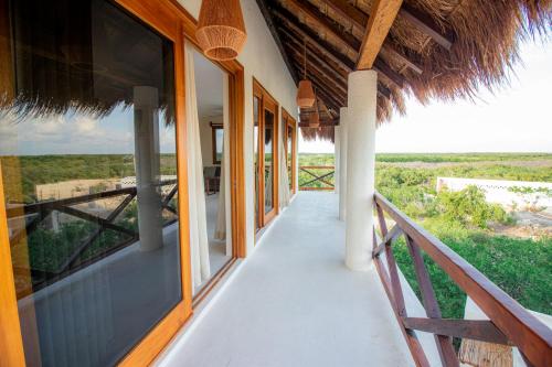 a balcony of a house with a view of the ocean at Hotel Luna Roja Holbox in Holbox Island