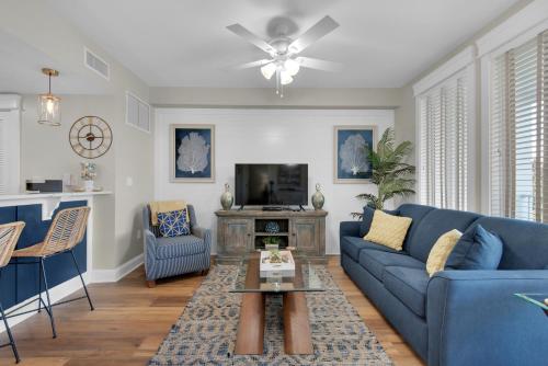 a living room filled with furniture and a tv at The Grand Sandestin in Destin