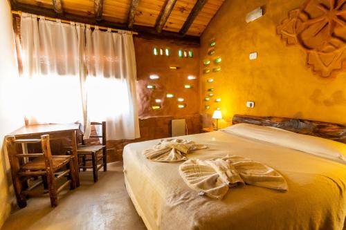 Una cama o camas en una habitación de EcoMalargüe Posada & Hostel