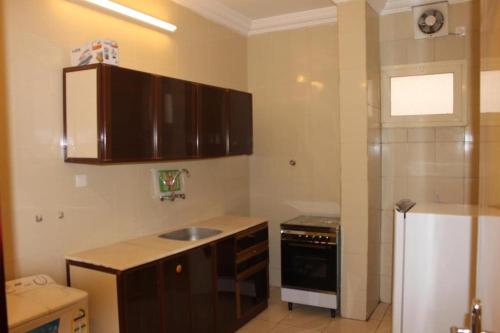 La cuisine est équipée d'un évier et d'un réfrigérateur. dans l'établissement Al Samia apartment, à Baljurashi