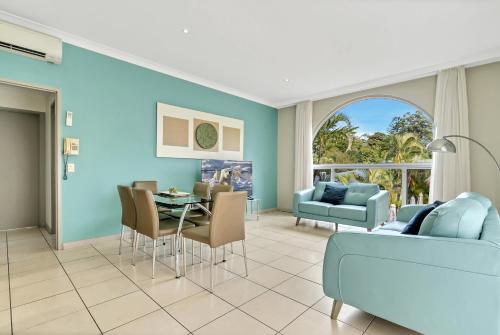 a living room with a couch and a table at Korora Bay Village Resort in Coffs Harbour