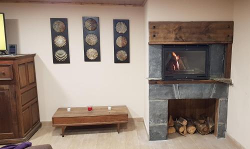 a living room with a fireplace and a tv at Mirador del Navia in Serandinas