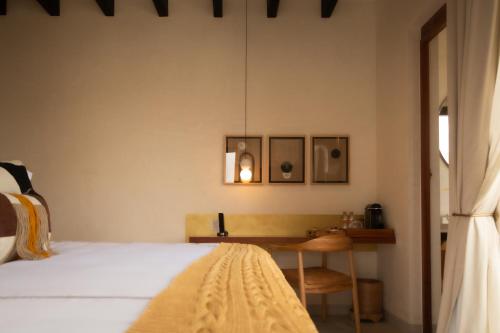 a bedroom with a bed and a wooden table at Cantera 1910 Hotel Boutique, Destination Hotel in San Miguel de Allende