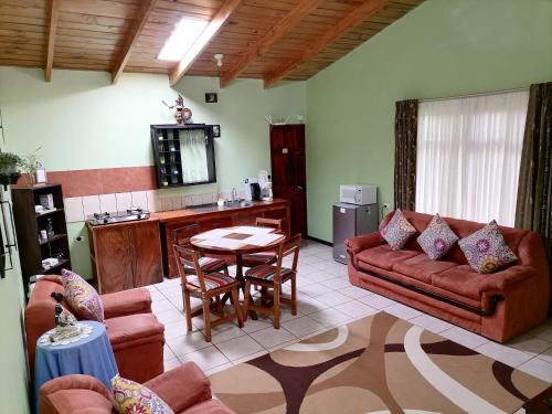 a living room with a couch and a table at Cassidini House in Monteverde Costa Rica