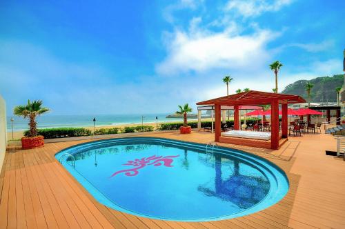 a swimming pool with a gazebo next to the beach at Sayan Terrace Hotel & Resort in Onjuku